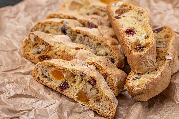 istock Italian Almond Biscotti biscuits in a rustic home made pottery bowl. Studded with almonds and cranberries, these twice-baked treats are aromatic and inviting. Ideal. 2232169462