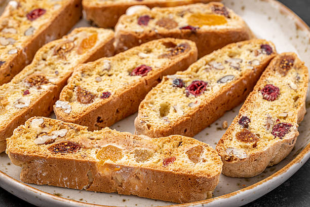istock Italian Almond Biscotti biscuits in a rustic home made pottery bowl. Studded with almonds and cranberries, these twice-baked treats are aromatic and inviting. Ideal. 2232169464