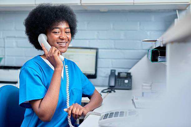 istock Smiling Medical Receptionist Answering Phone Call in a Modern Clinic Setting 2232170037
