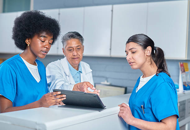 istock Medical Professionals Collaborating at Front Desk with a Tablet 2232170088