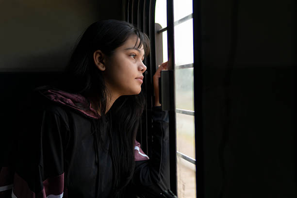 istock Serene young woman looking out through the train window and thinking while traveling. 2232170333