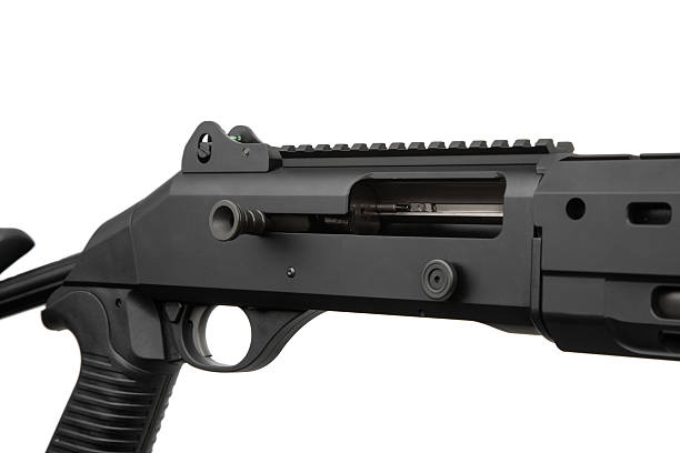 istock A modern black tactical shotgun with an adjustable stock and a red dot sight, isolated on a clean white background. 2232172038
