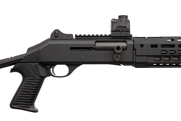 istock A modern black tactical shotgun with an adjustable stock and a red dot sight, isolated on a clean white background. 2232172056