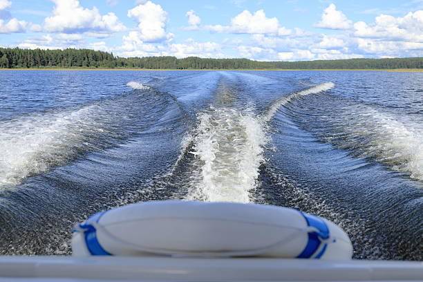 A teenager having fun tubing behind a boat on the Lake of Bays, Ontario, Canada