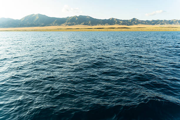 The high mountains and grassland by the lake, with azure lake water