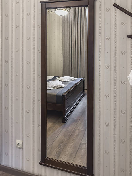 istock A freshly made bed is reflected in a mirror in a hotel room. Comfortable living. 2232173413