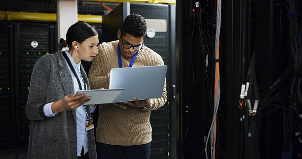 istock Laptop, engineer and team discussion in datacenter for firewall upgrade or IT maintenance. Server room, collaboration and people with tablet for software diagnostics, cybersecurity or problem solving 2232174358