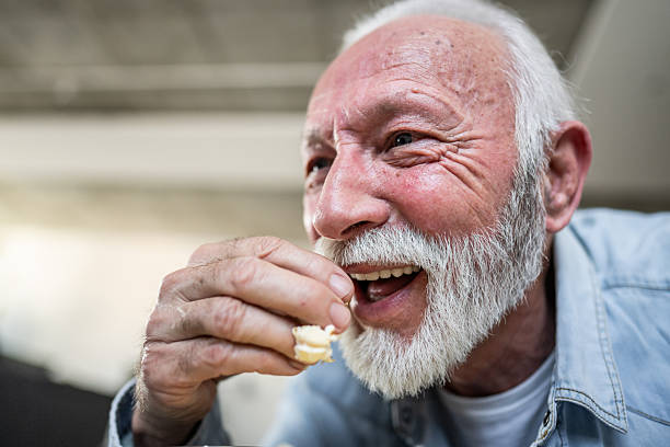 istock Happy senior man eating popcorn and having fun 2232174954