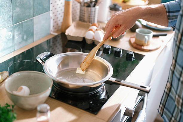 istock Man melting butter in frying pan for breakfast 2232176788
