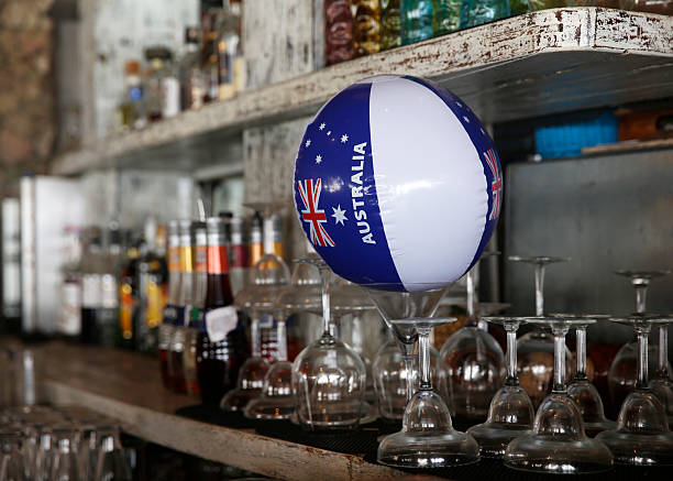 Close-up shot of Australian blue balloons placed on the bar shelves, for a festive Australia Day celebration.\n\nConcept theme: Australia Day celebration, national pride decorations, tropical outdoor party, bamboo hut event setup