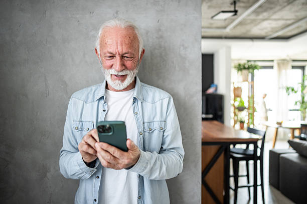 istock Happy senior man using smartphone at home: enjoying modern technology 2232178822