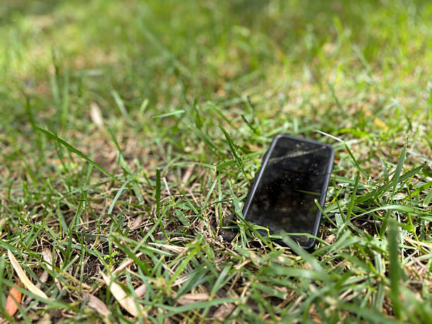 istock Mobile phone forgotten and lost on grass 2232179194