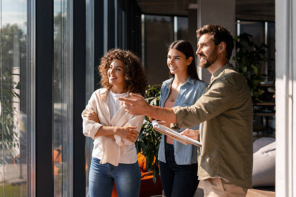 istock Business Team Planning Strategy While Looking Out Office Window 2232180688
