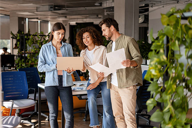 istock Coworkers discussing a project in the office using laptop and documents 2232180710