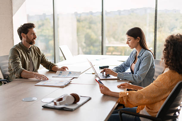istock Business team working together in modern office analyzing financial charts and reports 2232181140
