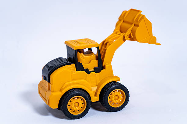 istock Yellow toy excavator lifting its bucket on white background 2232181633