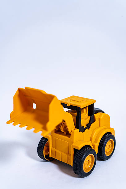 istock Yellow toy excavator ready for construction playtime on white background 2232181767