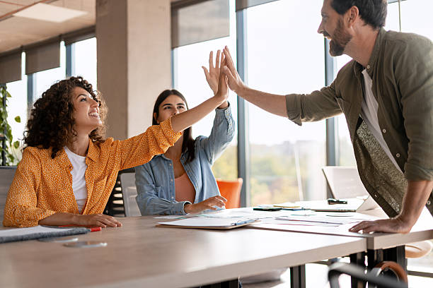 istock Celebrating business success with high five in the office 2232181782