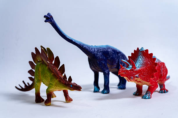 istock Colorful plastic dinosaurs representing triceratops, stegosaurus, and brachiosaurus 2232182335