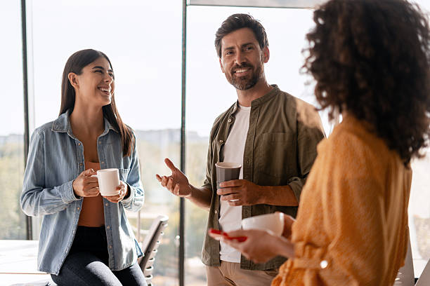 istock Coworkers enjoying a coffee break and chatting together 2232183572
