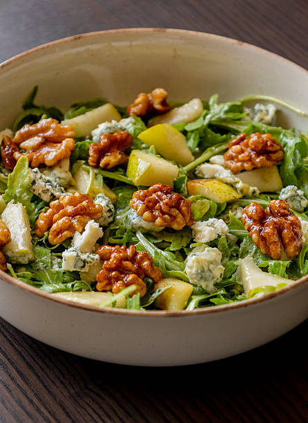 istock healthy fall salad with arugula pear cheese and candied walnuts 2232185378