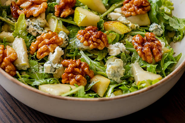 istock healthy fall salad with arugula pear cheese and candied walnuts 2232185399