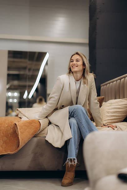 istock Stylish Woman Relaxing on Comfortable Bed in Modern Showroom Setting 2232186853