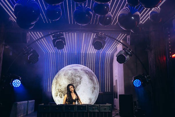 DJ Performing With Futuristic Lighting and Giant Moon Backdrop
