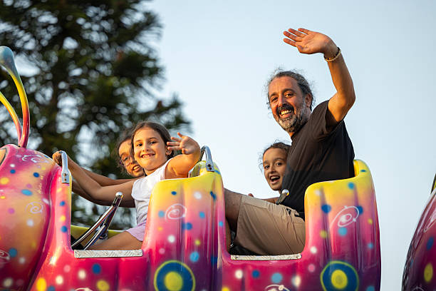 istock people enjoying rides and attractions at an amusement park 2232188792