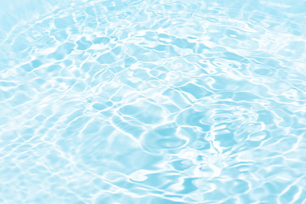 istock Blue water with ripples on the surface. Defocus blurred transparent blue colored clear calm water surface texture with splashes and bubbles. Water waves with shining pattern texture background. 2232189810