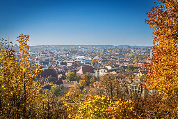 istock Stunning autumn view over Vilnius showcasing colorful trees, historic rooftops, and a clear blue sky 2232190246