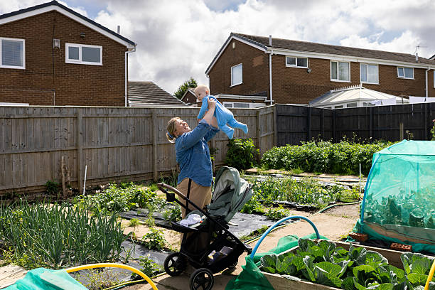 istock Mother Introducing Baby to Allotment Garden 2232190287