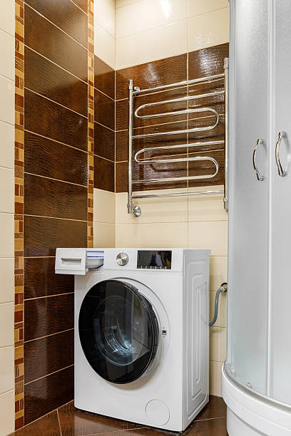 istock Contemporary Modern Bathroom Featuring a Washing Machine and Shower 2232191005