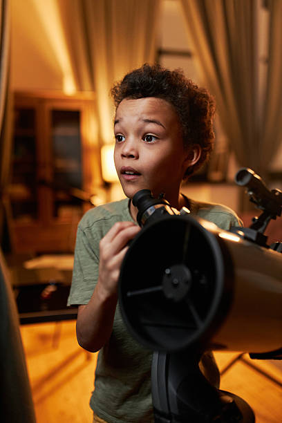 istock Curious kid enjoying watching stars and planets 2232192292