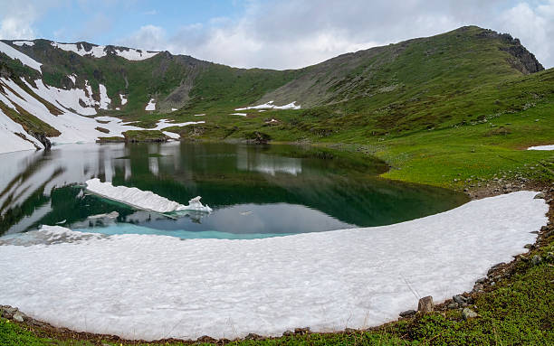 istock Glacial lake in low clouds in changeable weather 2232194289