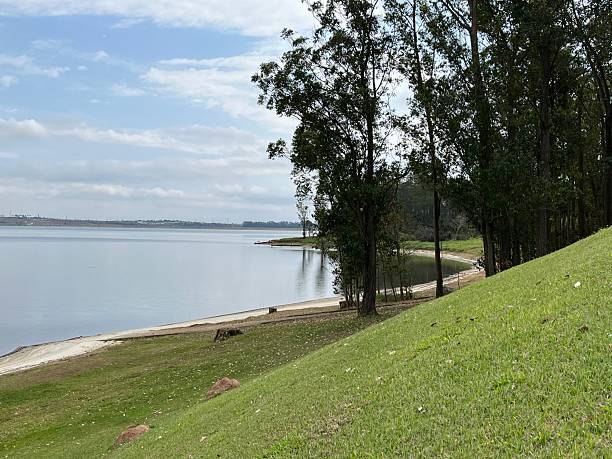 istock Hill covered by green grass along lake side 2232196349