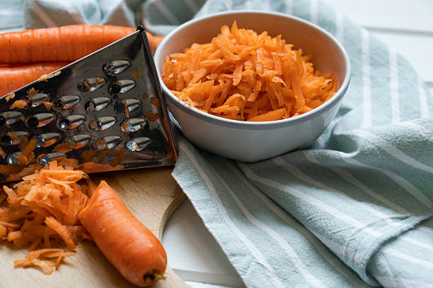 Fresh organic shredded carrots on cutting board