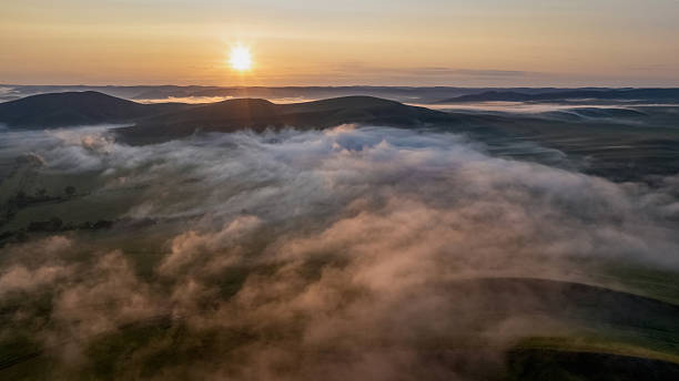 istock sun rises over a picturesque mountain valley 2232198194