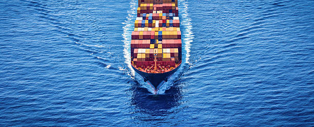 istock Aerial front view of a large container cargo freight ship sailing over the ocean 2232198676