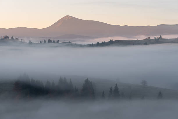 istock Autumn Mountain Valley Covered With Morning Fog 2232199834