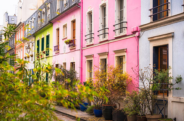 Colourfully painted houses on a traditional street in central Paris, France.