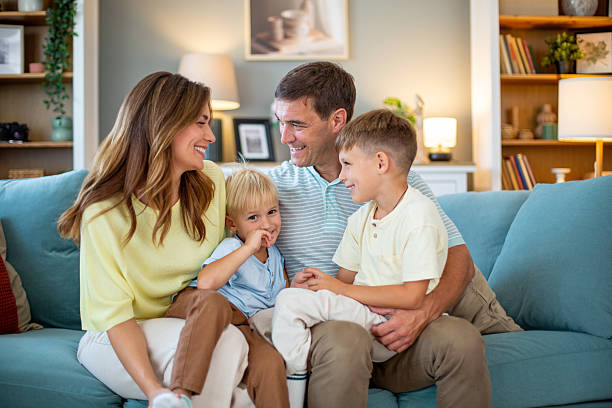 istock Happy family relaxing together on sofa at home, sharing quality time 2232202819
