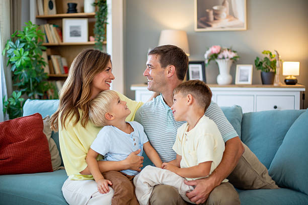 istock Happy family relaxing together on sofa at home 2232202821