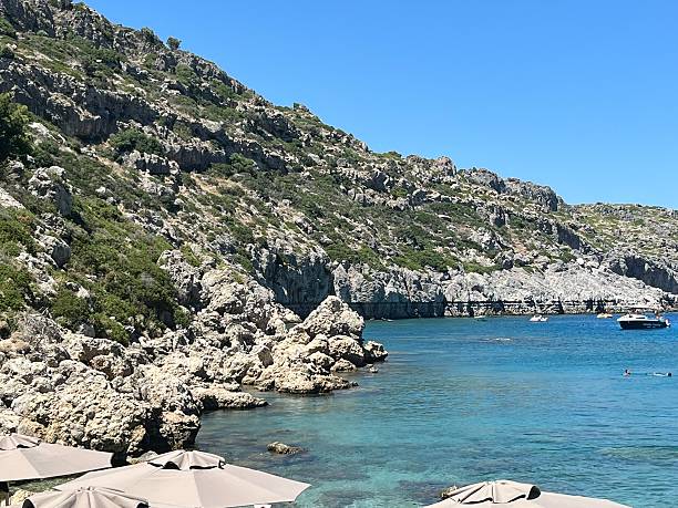 Greece- Rhodes- Anthony Quinn Bay. It is a scenic cove in Faliraki,officially named Vaghies but renamed after the actor because of its role in the 1961 film The Guns of Navarone. The bay's turquoise waters, rocky setting, and emerald-toned cliffs make it a popular spot for swimming, snorkeling, and relaxation, and its beauty inspired the actor himself, who had a fondness for the location
