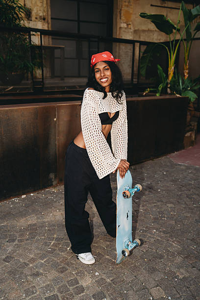 istock Young skater posing with her skateboard 2232207298