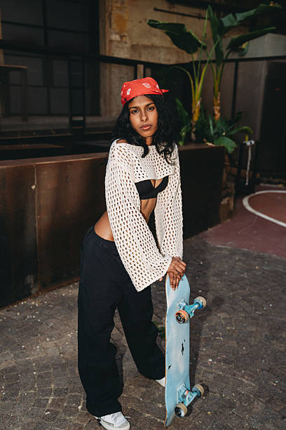 istock Young skater posing with her skateboard in an urban environment 2232208001