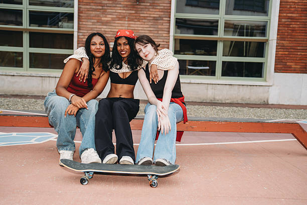istock Young women posing with skateboard in urban setting 2232208702