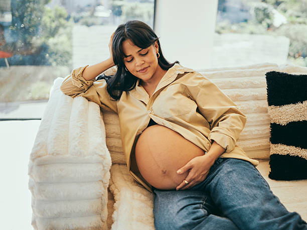 istock Relaxed Pregnant Woman Resting on Cozy Couch 2232209027