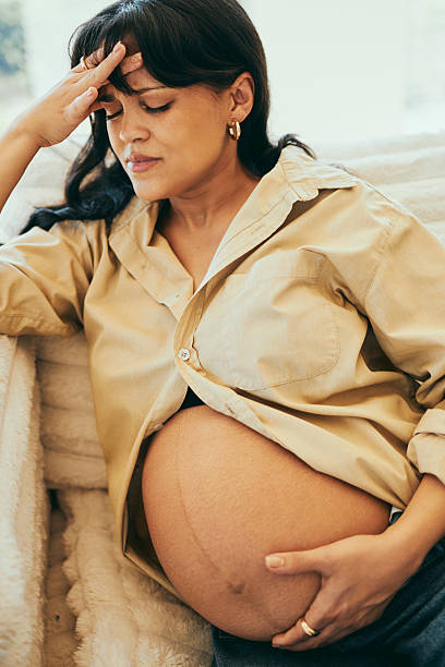 istock Pregnant Woman Resting on Cozy Couch with a Headache 2232209035