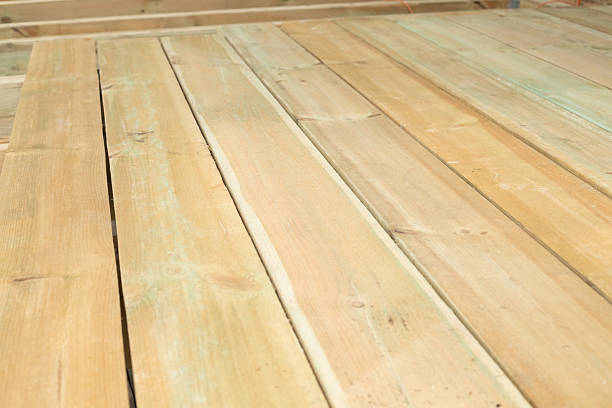istock Wooden planks. Laying the floor. Construction works. 2232211033